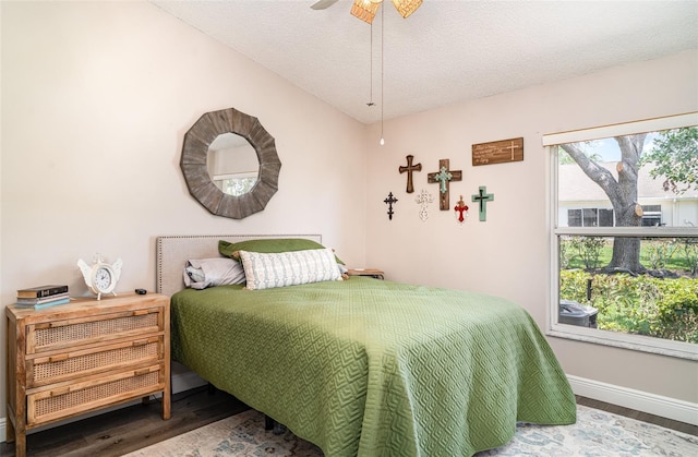 2403 Nantucket Field Way Unit 27, Sun City Center, FL 33573 - bedroom with wood finished floors, a textured ceiling, baseboards, and a ceiling fan