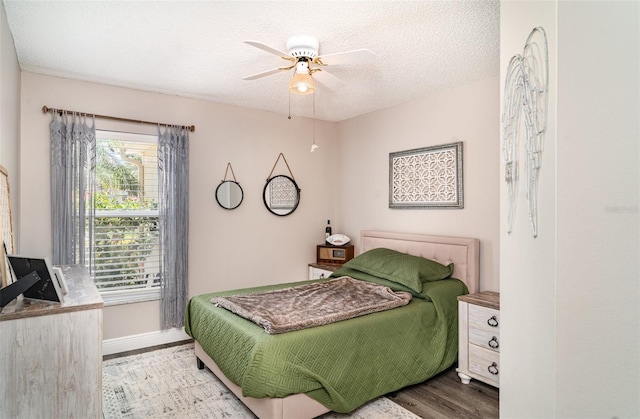 2403 Nantucket Field Way Unit 27, Sun City Center, FL 33573 - bedroom with wood finished floors, a textured ceiling, baseboards, and ceiling fan