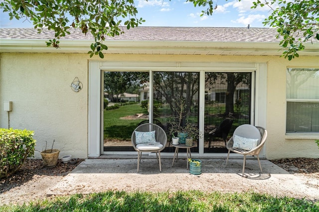 2403 Nantucket Field Way Unit 27, Sun City Center, FL 33573 - property entrance with stucco siding and a shingled roof