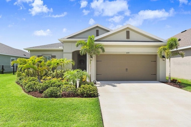 6097 Golden Nettle Dr, Apollo Beach, FL 33572 - view of front of property featuring an attached garage, concrete driveway, and stucco siding
