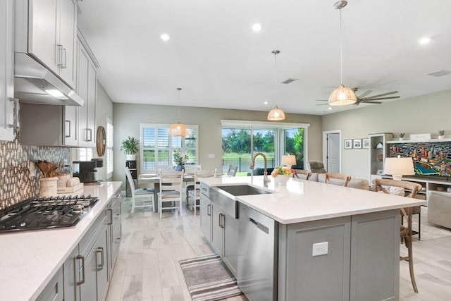 6097 Golden Nettle Dr, Apollo Beach, FL 33572 - kitchen featuring stainless steel appliances, gray cabinets, a sink, and recessed lighting