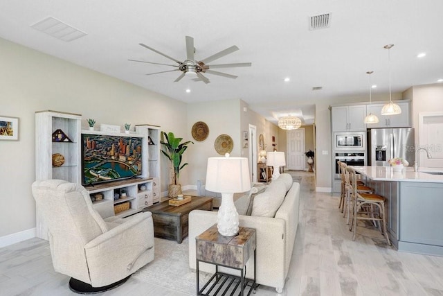 6097 Golden Nettle Dr, Apollo Beach, FL 33572 - living room featuring ceiling fan, recessed lighting, baseboards, and light wood-style flooring