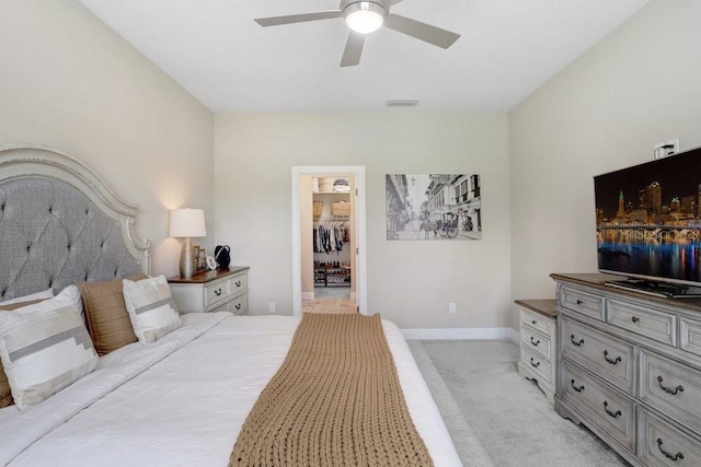 6097 Golden Nettle Dr, Apollo Beach, FL 33572 - bedroom with light carpet, a spacious closet, baseboards, and ceiling fan