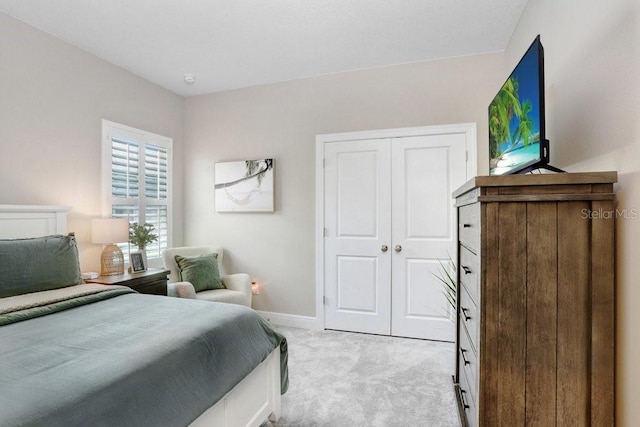 6097 Golden Nettle Dr, Apollo Beach, FL 33572 - bedroom with light carpet, baseboards, and a closet