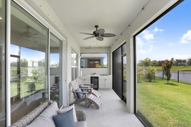 6097 Golden Nettle Dr, Apollo Beach, FL 33572 - sunroom / solarium with ceiling fan, wine cooler, and a water view