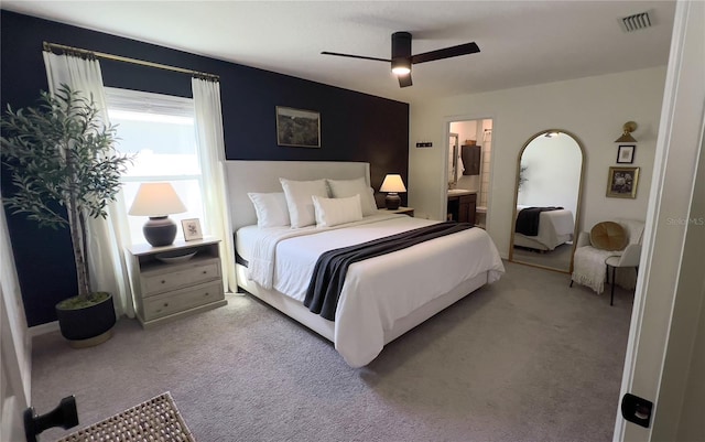 10123 Carp Hollow Rd, Sun City Center, FL 33573 - carpeted bedroom with connected bathroom and ceiling fan