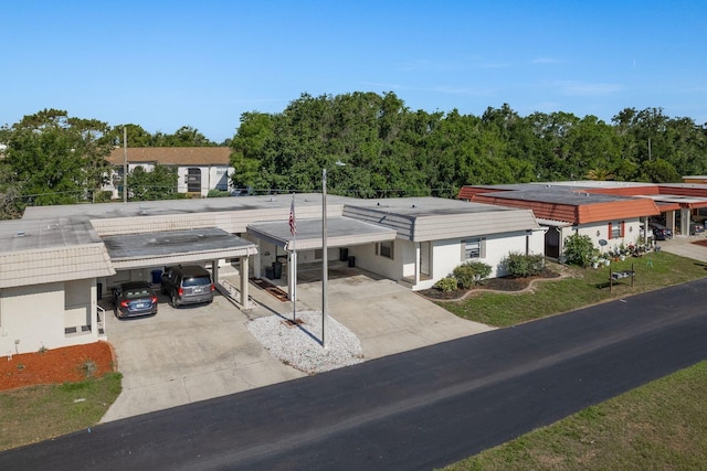 4039 La Pasida Ln, New Port Richey, FL 34655 - view of building exterior with driveway and an attached carport