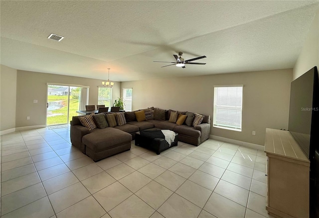 1509 Venice Ln, Davenport, FL 33896 - living area featuring a chandelier, baseboards, light tile patterned floors, a ceiling fan, and a textured ceiling