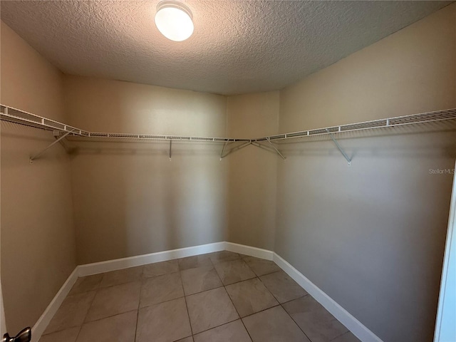 1509 Venice Ln, Davenport, FL 33896 - walk in closet with light tile patterned flooring
