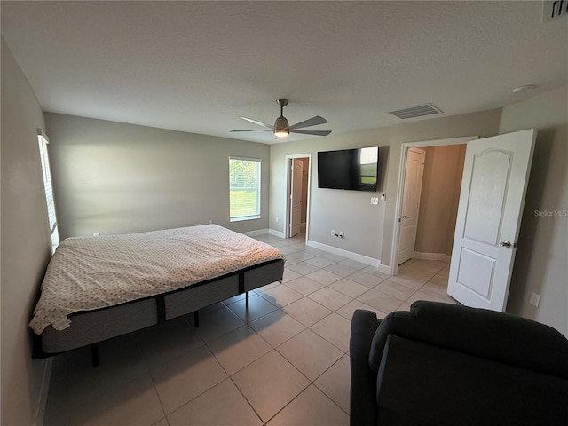 1509 Venice Ln, Davenport, FL 33896 - bedroom with light tile patterned flooring, baseboards, and ceiling fan