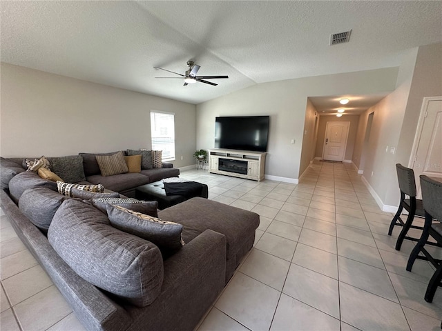 1509 Venice Ln, Davenport, FL 33896 - living area with light tile patterned flooring, a ceiling fan, lofted ceiling, a textured ceiling, and baseboards