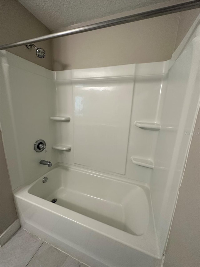 1509 Venice Ln, Davenport, FL 33896 - full bath featuring tile patterned floors, shower / bathtub combination, and a textured ceiling