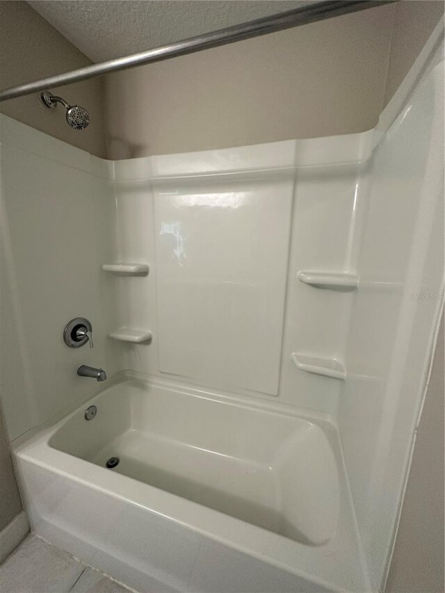 1509 Venice Ln, Davenport, FL 33896 - bathroom with shower / washtub combination and tile patterned floors
