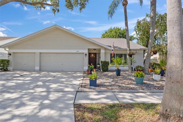 11927 Steppingstone Blvd, Tampa, FL 33635 - ranch-style home featuring a garage, driveway, a shingled roof, and stucco siding