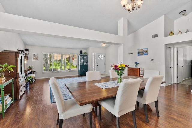 11927 Steppingstone Blvd, Tampa, FL 33635 - dining room featuring vaulted ceiling, dark wood-type flooring, a chandelier, and baseboards