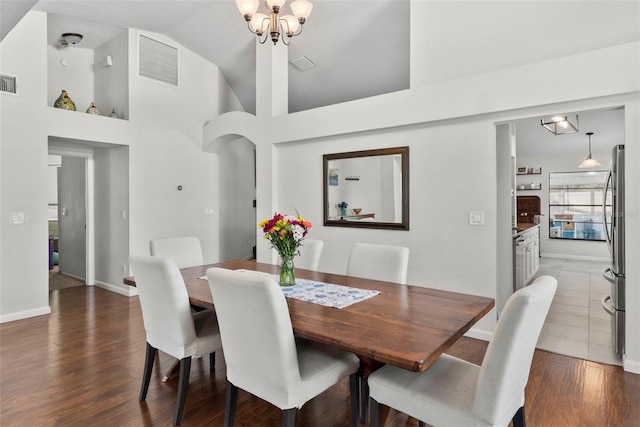 11927 Steppingstone Blvd, Tampa, FL 33635 - dining space with dark wood-type flooring, baseboards, high vaulted ceiling, and a chandelier