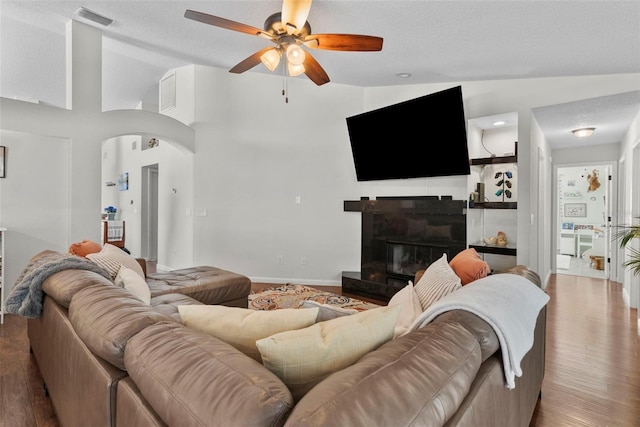 11927 Steppingstone Blvd, Tampa, FL 33635 - living area with vaulted ceiling, ceiling fan, arched walkways, wood finished floors, and baseboards