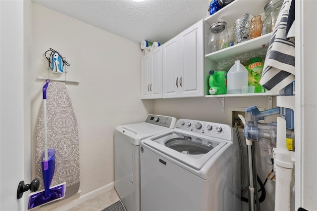 11927 Steppingstone Blvd, Tampa, FL 33635 - washroom with separate washer and dryer, cabinet space, a textured ceiling, baseboards, and light tile patterned floors
