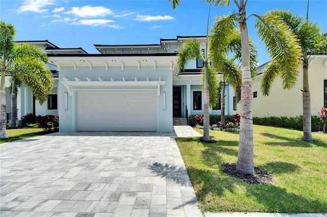 6530 Simone Shores Cir, Apollo Beach, FL 33572 - view of front facade with a front yard, an attached garage, decorative driveway, and stucco siding