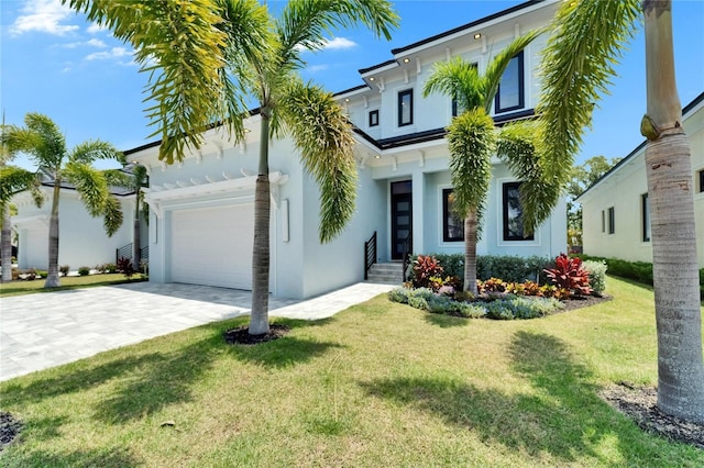 6530 Simone Shores Cir, Apollo Beach, FL 33572 - view of front of home featuring an attached garage, stucco siding, a front lawn, and decorative driveway