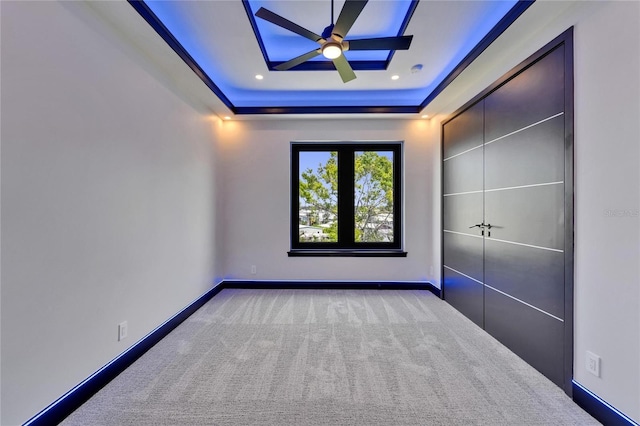 6530 Simone Shores Cir, Apollo Beach, FL 33572 - unfurnished bedroom with a tray ceiling, carpet, baseboards, and a skylight