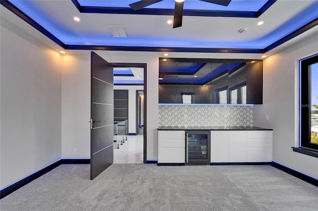 6530 Simone Shores Cir, Apollo Beach, FL 33572 - indoor dry bar with wine cooler, a raised ceiling, carpet flooring, backsplash, and baseboards
