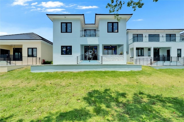 6530 Simone Shores Cir, Apollo Beach, FL 33572 - back of property with stucco siding, a lawn, a balcony, and a patio