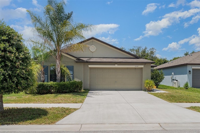 10104 Carloway Hills Dr, Wimauma, FL 33598 - ranch-style house featuring stucco siding, an attached garage, driveway, and a front lawn