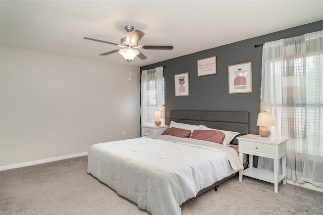 10104 Carloway Hills Dr, Wimauma, FL 33598 - bedroom with light colored carpet, baseboards, and ceiling fan
