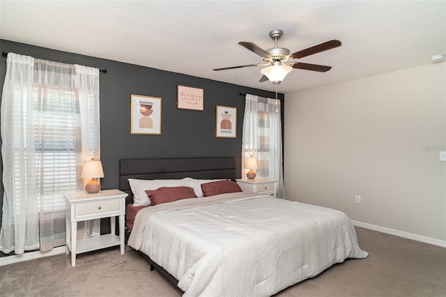10104 Carloway Hills Dr, Wimauma, FL 33598 - bedroom featuring light colored carpet, baseboards, and ceiling fan