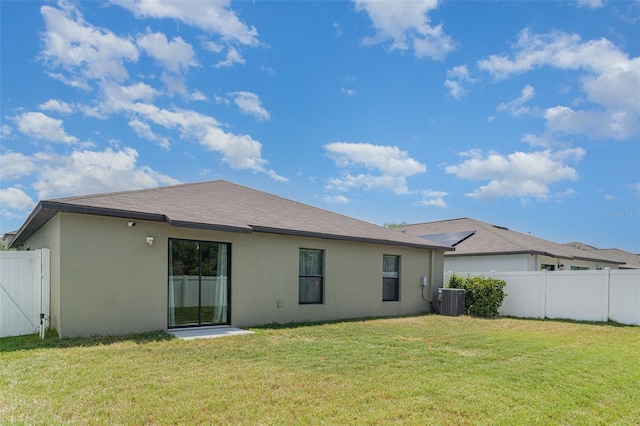 10104 Carloway Hills Dr, Wimauma, FL 33598 - rear view of house featuring central AC unit and stucco siding