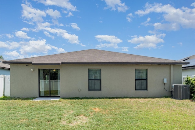 10104 Carloway Hills Dr, Wimauma, FL 33598 - rear view of house with cooling unit, stucco siding, and a lawn