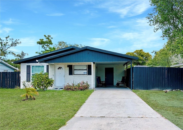 2606 E 97th Ave, Tampa, FL 33612 - view of front facade with concrete driveway and an attached carport
