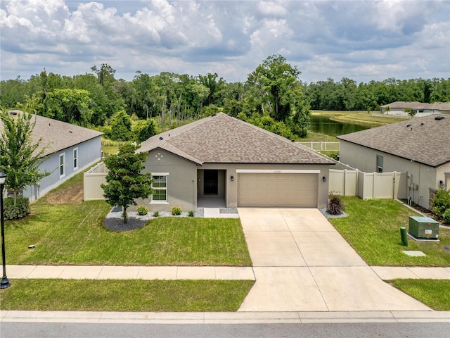 12170 Gothic Rd, Spring Hill, FL 34610 - view of front of property with a garage, driveway, a shingled roof, stucco siding, and a water view