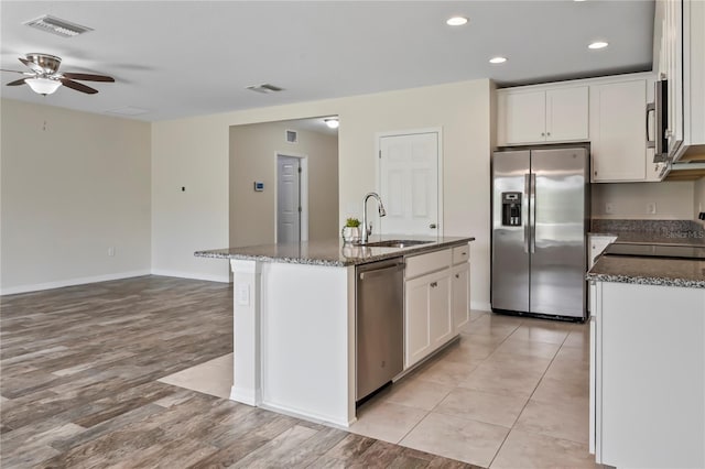 12170 Gothic Rd, Spring Hill, FL 34610 - kitchen with stainless steel appliances, a sink, a ceiling fan, dark stone counters, and recessed lighting