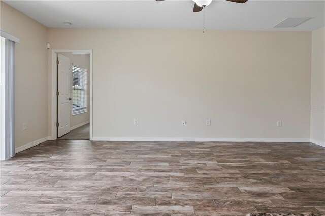 12170 Gothic Rd, Spring Hill, FL 34610 - empty room with a ceiling fan, wood finished floors, and baseboards