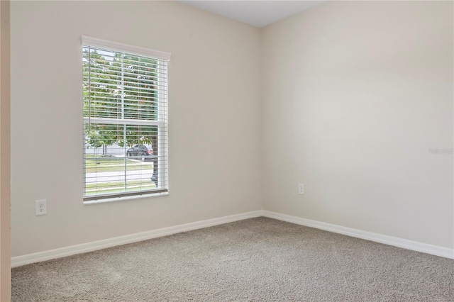 12170 Gothic Rd, Spring Hill, FL 34610 - carpeted empty room with plenty of natural light and baseboards
