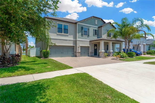 11612 Sunburst Marble Rd, Riverview, FL 33579 - view of front of house with decorative driveway, a garage, stucco siding, a front lawn, and stone siding