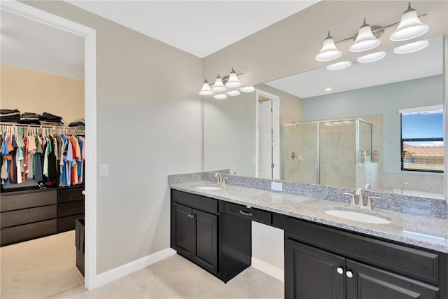 11612 Sunburst Marble Rd, Riverview, FL 33579 - full bath with a shower stall, double vanity, a spacious closet, tile patterned floors, and baseboards