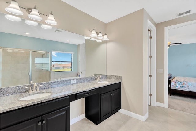 11612 Sunburst Marble Rd, Riverview, FL 33579 - ensuite bathroom with double vanity, a shower stall, tile patterned flooring, and baseboards