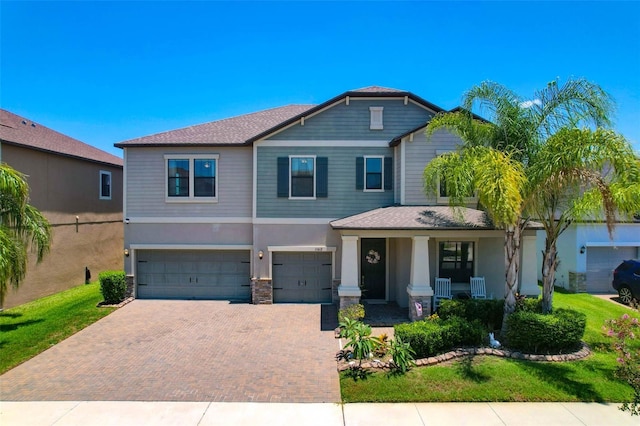 11612 Sunburst Marble Rd, Riverview, FL 33579 - craftsman inspired home featuring covered porch, an attached garage, decorative driveway, and stucco siding