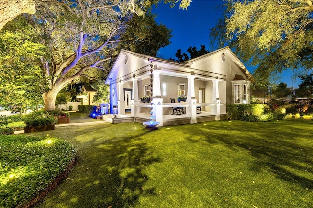 213 N Hesperides St, Tampa, FL 33609 - back of property featuring a lawn and stucco siding