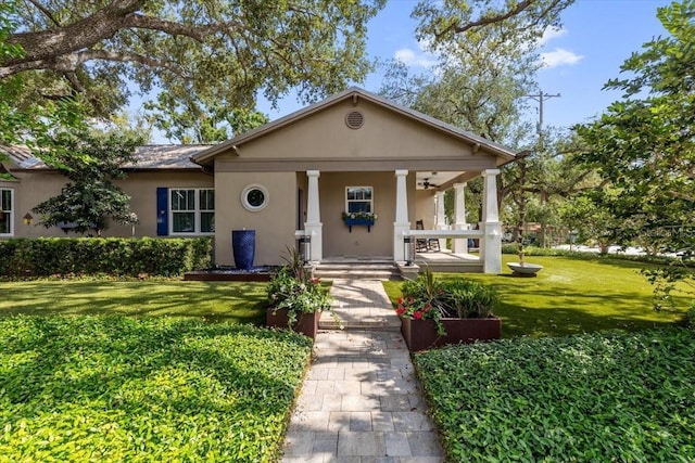 213 N Hesperides St, Tampa, FL 33609 - greek revival house featuring covered porch, stucco siding, and a front yard