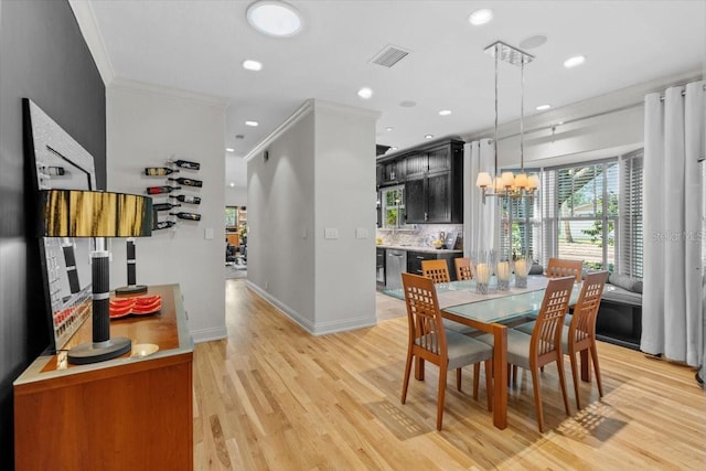 213 N Hesperides St, Tampa, FL 33609 - dining area featuring crown molding, light wood-style floors, recessed lighting, baseboards, and a chandelier