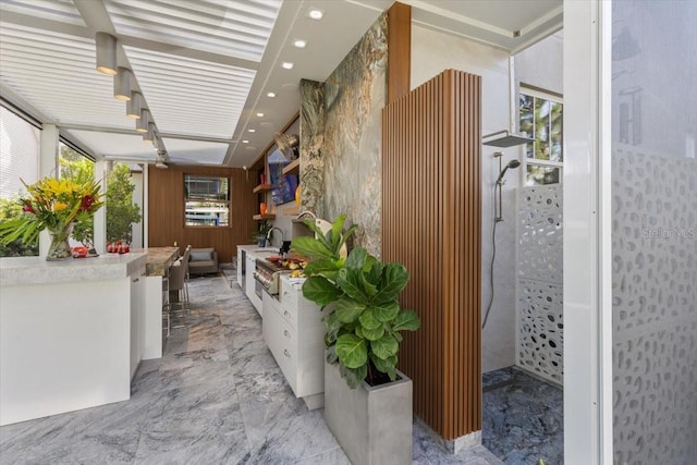 213 N Hesperides St, Tampa, FL 33609 - hallway with light marble finish floors, a sink, and recessed lighting
