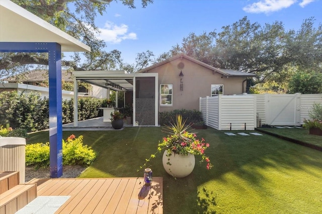 213 N Hesperides St, Tampa, FL 33609 - back of property featuring a gate, a deck, and stucco siding