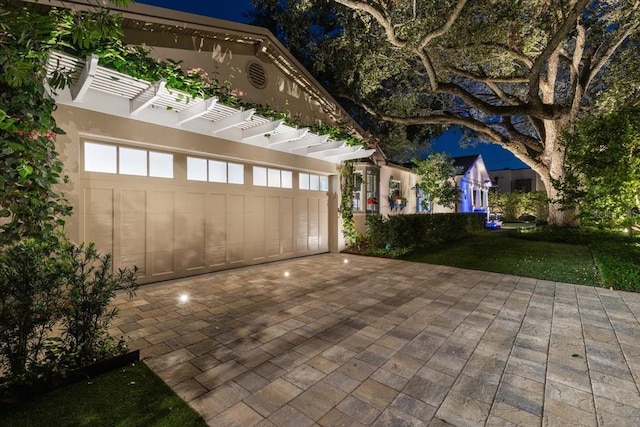 213 N Hesperides St, Tampa, FL 33609 - view of patio with driveway, a garage, and a pergola