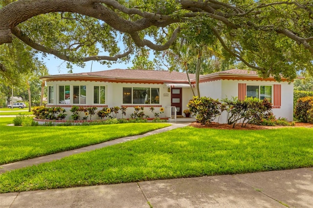 5800 3rd St S, Saint Petersburg, FL 33705 - ranch-style home featuring a front lawn and stucco siding