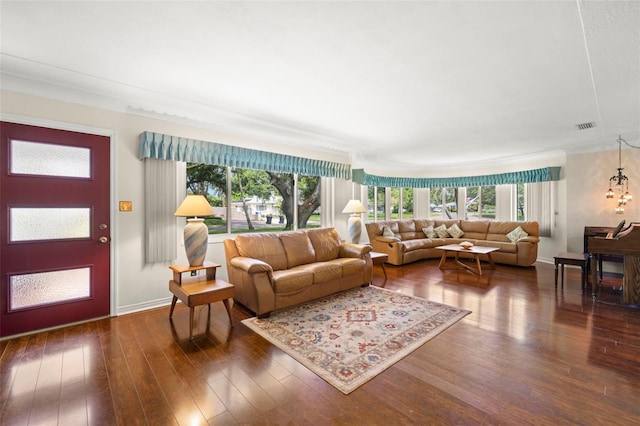 5800 3rd St S, Saint Petersburg, FL 33705 - living area featuring healthy amount of natural light, dark wood finished floors, and ornamental molding