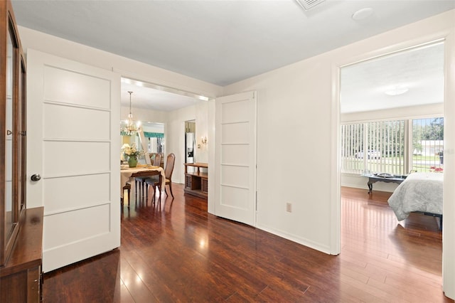 5800 3rd St S, Saint Petersburg, FL 33705 - foyer entrance with dark wood-style floors, plenty of natural light, and a chandelier